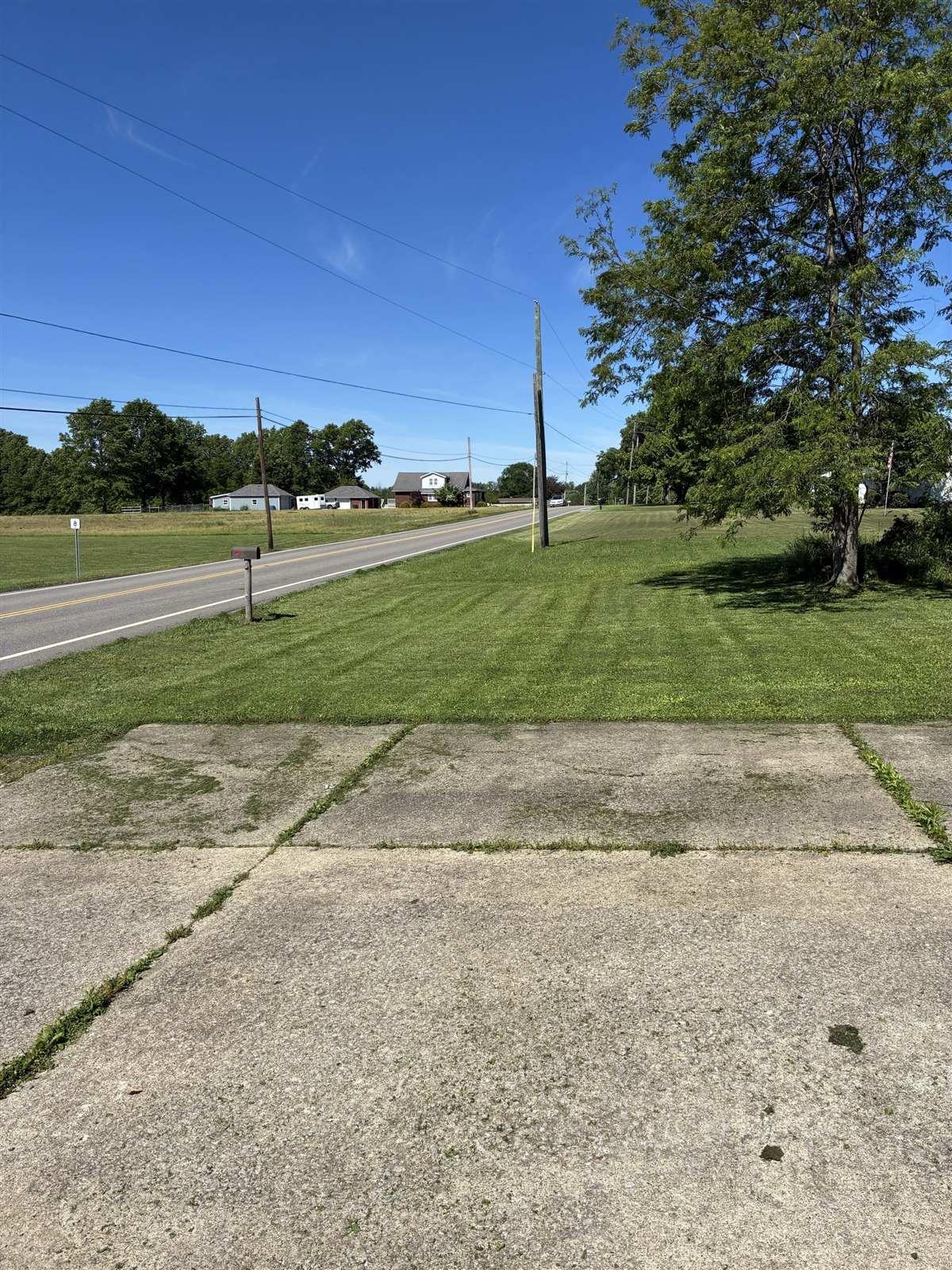 Mowed corner lot with clean stripes along the road